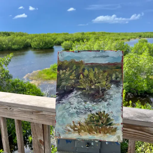 A small oil painting depicting a tranquil landscape with trees, water, and a distant view of a river and greenery.