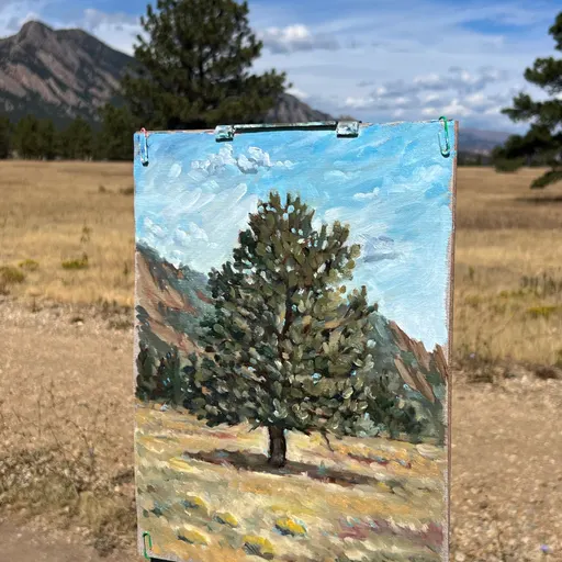 A small oil painting depicting a solitary tree in a dry landscape with distant mountains under a blue sky.
