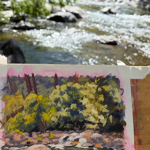 A watercolor painting of a river scene with yellow flowers in the foreground and a rocky riverbank in the background.